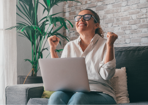 person excited sitting at their computer